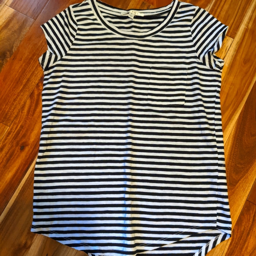 Gently used Cyrus size small black/white striped shirt with rounded bottom